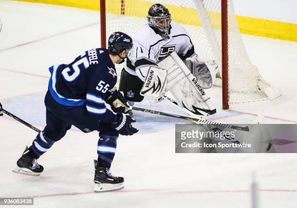 Los Angeles Kings goalie Jack Campbell poke checks Winnipeg Jets forward Mark Scheifele during the NHL game between the Winnipeg Jets and the Los...