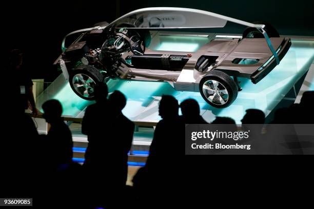 Members of the media look at the drivetrain of the General Motors Co. Chevrolet Volt electric vehicle during the 2009 LA Auto Show at the Los Angeles...