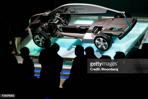 Members of the media look at the drivetrain of the General Motors Co. Chevrolet Volt electric vehicle during the 2009 LA Auto Show at the Los Angeles...