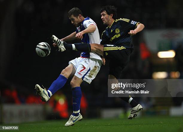 Brett Emerton of Blackburn Rovers is challenged by Yury Zhirkov of Chelsea during the Carling Cup Quarter Final match between Blackburn Rovers and...