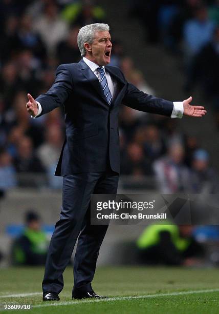 Manchester City manager Mark Hughes shouts instructions to his players during the Carling Cup quarter final match between Manchester City and Arsenal...