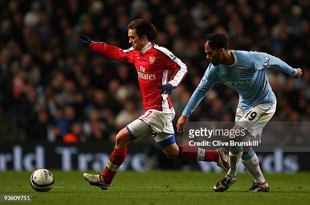 Tomas Rosicky of Arsenal moves away from Joleon Lescott of Manchester City during the Carling Cup quarter final match between Manchester City and...