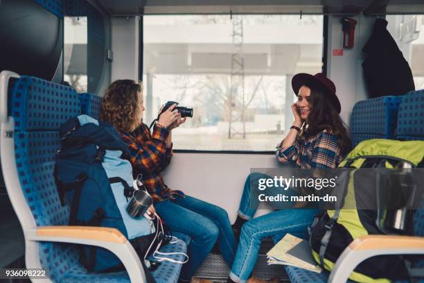 couple traveling in train and vlogging - the weekend in news around the world stock pictures, royalty-free photos & images