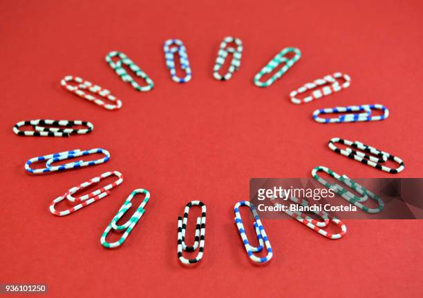 office clips in circle on red background - plastic design furniture stock pictures, royalty-free photos & images