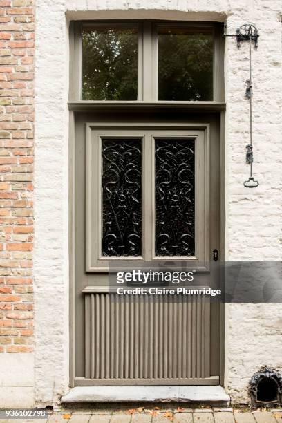 classic wooden door painted grey/green with 2 glass panels - claire plumridge stock-fotos und bilder