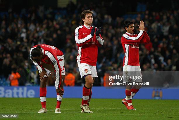 Sanchez Watt of Arsenal bends over as Tomas Rosicky and Carlos Vela applaud the supporters as they walk off the pitch after defeat in the Carling Cup...