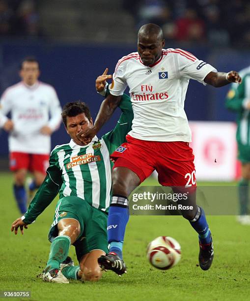 Guy Demel of Hamburg challenges Markus Katzer of Wien during the UEFA Europa League Group C match between Hamburger SV and SK Rapid Wien at HSH...