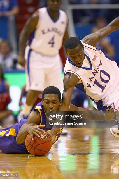 Elijah Muhammad of the Tennessee Tech Golden Eagles battles Tyshawn Taylor of the Kansas Jayhawks for a loose ball during the game on November 27,...