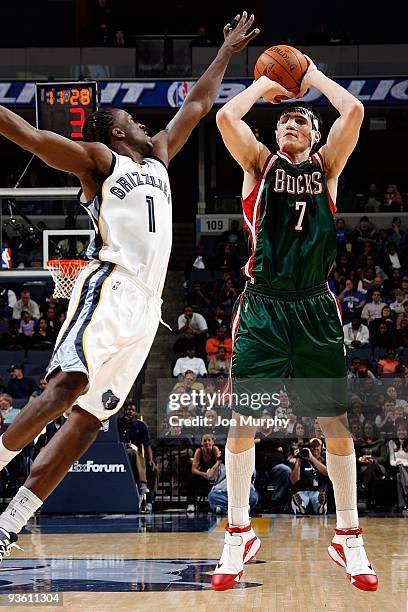 Ersan Ilyasova of the Milwaukee Bucks shoots under pressure against DeMarre Carroll of the Memphis Grizzlies during the game on November 21, 2009 at...