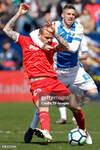 Ruben Perez of Leganes and Sandro Ramirez of Sevilla battle for the ball during the La Liga match between Leganes and Sevilla at Estadio Municipal de...