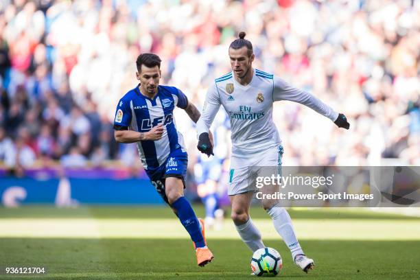 Gareth Bale of Real Madrid is tackled by Hernan Arsenio Perez of Deportivo Alaves during the La Liga 2017-18 match between Real Madrid and Deportivo...