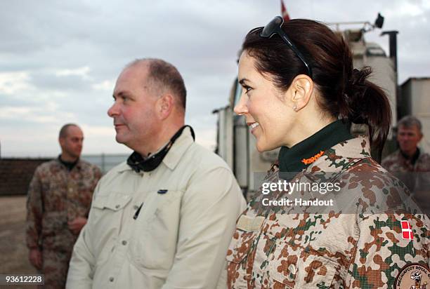 In this handout photo provided by The Danish Ministry of Defence, HRH Crown Princess Mary of Denmark and Denmark's Defence Minister Soeren Gade visit...