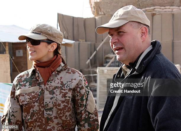 In this handout photo provided by The Danish Ministry of Defence, HRH Crown Princess Mary of Denmark and Denmark's Defence Minister Soeren Gade visit...