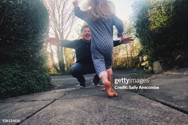 child running to meet her father - homecoming stock pictures, royalty-free photos & images