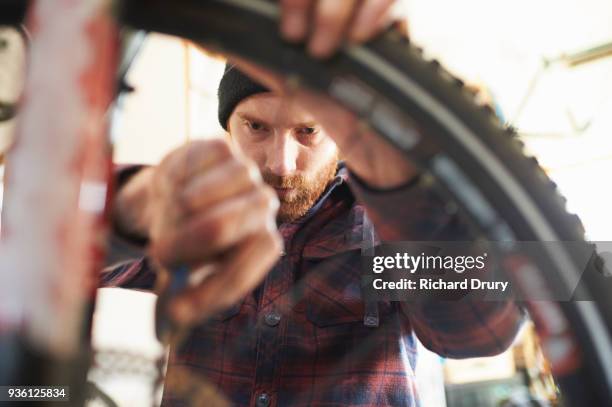 bicycle mechanic at work - bike mechanic stockfoto's en -beelden