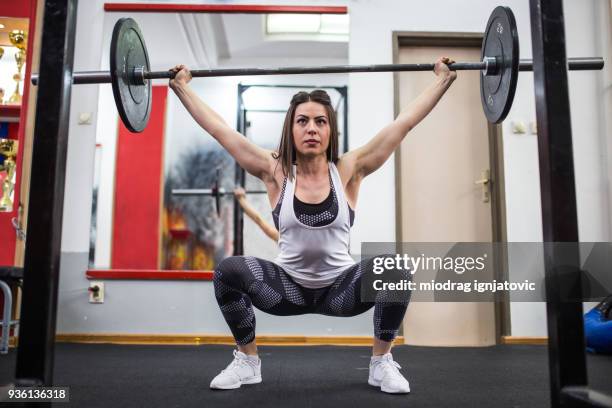 powerful woman - snatch weightlifting stock pictures, royalty-free photos & images