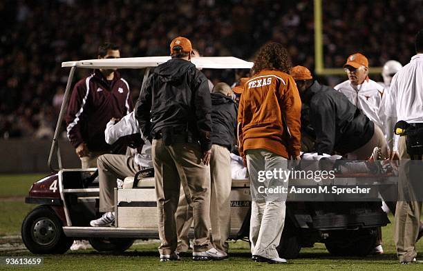 Cornerback Deon Beasley of the Texas Longhorns is carted off the field due to an injury against the Texas A&M Aggies in the second half at Kyle Field...