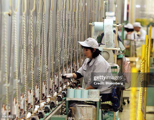 Worker inspects Hitachi Ltd. Refrigerators at Hitachi Appliances Inc.'s Tochigi plant in Tochigi prefecture, Japan, on Wednesday, Dec. 2, 2009....