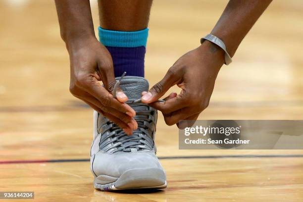 Detailed view of the Nike shoe worn by Michael Kidd-Gilchrist of the Charlotte Hornets as he ties it during the second half of a NBA game against the...