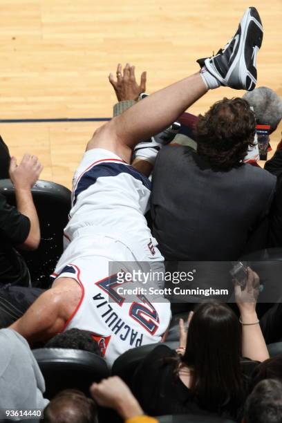 Zaza Pachulia of the Atlanta Hawks dives into the stands after a loose ball during a game against the Toronto Raptors on December 2, 2009 at Philips...