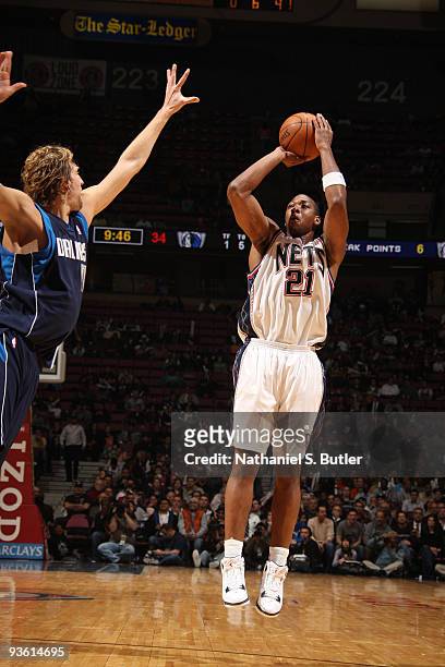 Bobby Simmons of the New Jersey Nets shoots against Dirk Nowitzki of the Dallas Mavericks on December 2, 2009 at the IZOD Center in East Rutherford,...