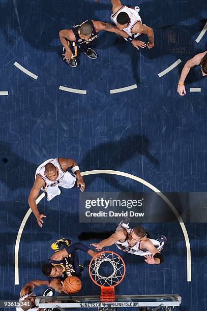 Danny Granger of the Indiana Pacers lays the ball up over Brook Lopez and Bobby Simmons of the New Jersey Nets during the game on November 17, 2009...