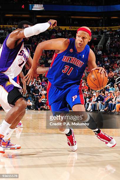 Charlie Villanueva of the Detroit Pistons makes a move to the basket against Amar'e Stoudemire of the Phoenix Suns during the game at US Airways...