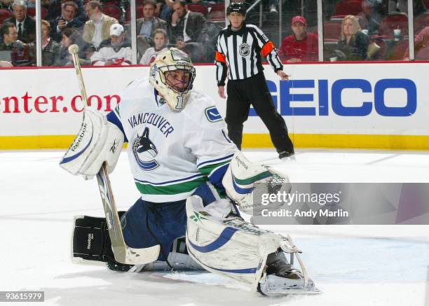 Goaltender Roberto Luongo of the Vancouver Canucks makes a glove save against the New Jersey Devils during their game at the Prudential Center on...