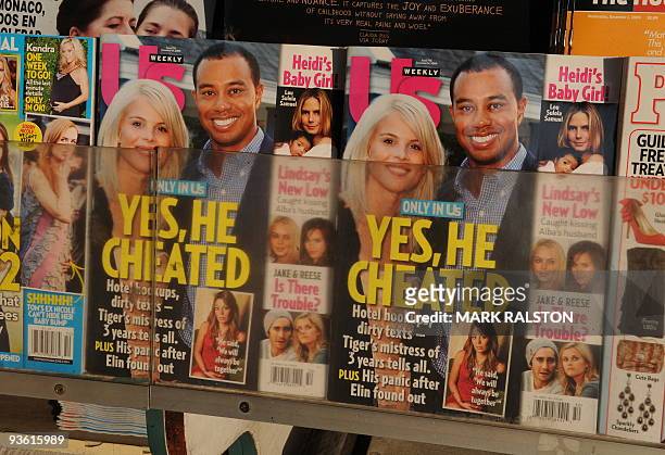 Copies of Us Weekly magazine featuring the story on Tiger Woods and the interview with alleged mistress Jaimee Grubbs are seen for sale on the...