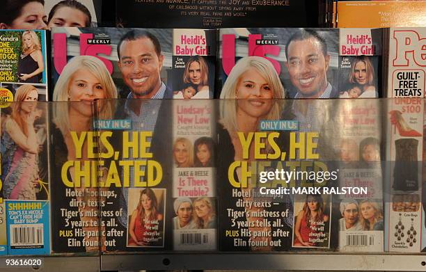 Copies of Us Weekly magazine featuring the story on Tiger Woods and the interview with alleged mistress Jaimee Grubbs are seen for sale on the...