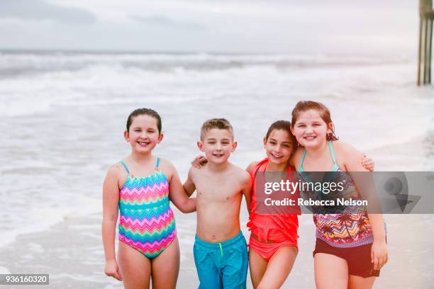 portrait of boy and three girls on beach, dauphin island, alabama, usa - alabama lifestyles stock pictures, royalty-free photos & images