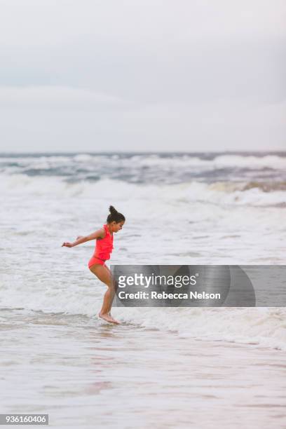 girl jumping ocean waves, dauphin island, alabama, usa - alabama lifestyles stock pictures, royalty-free photos & images