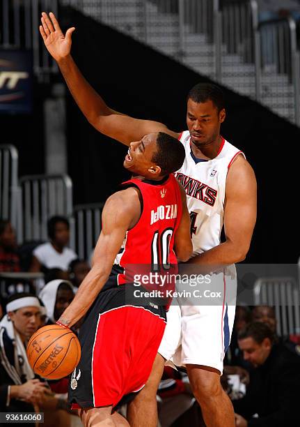 DeMar DeRozan of the Toronto Raptors draws a blocking foul while running into Jason Collins of the Atlanta Hawks at Philips Arena on December 2, 2009...