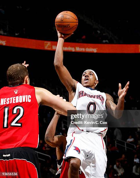 Jeff Teague of the Atlanta Hawks shoots over Rasho Nesterovic of the Toronto Raptors at Philips Arena on December 2, 2009 in Atlanta, Georgia. NOTE...