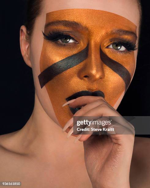 studio portrait of bare shouldered young woman with bronze on face and black lipstick, close up - beautiful bare women fotografías e imágenes de stock