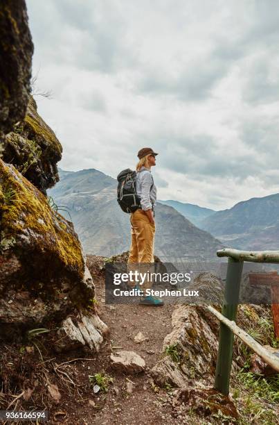 female hiker looking out at distant mountains, pisac, cusco, peru - pisac stock pictures, royalty-free photos & images