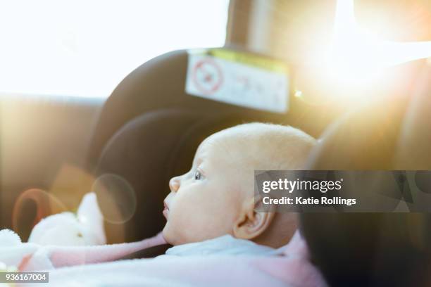 young baby in car seat in car, close-up - baby car seat stock pictures, royalty-free photos & images