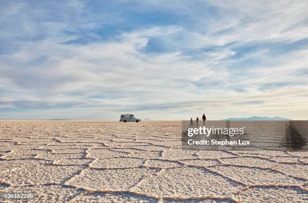 mother and sons walking across salt flats, recreational vehicle in background, salar de uyuni, uyuni, oruro, bolivia, south america - bolivia stock pictures, royalty-free photos & images