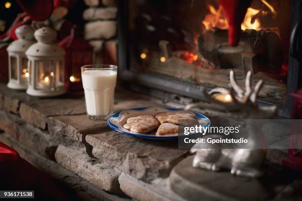 cookies and milk, for santa, left beside fireplace - milk and cookies stock pictures, royalty-free photos & images