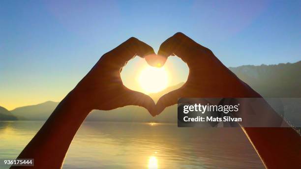 heart shape and sun - arms raised sunrise stock pictures, royalty-free photos & images