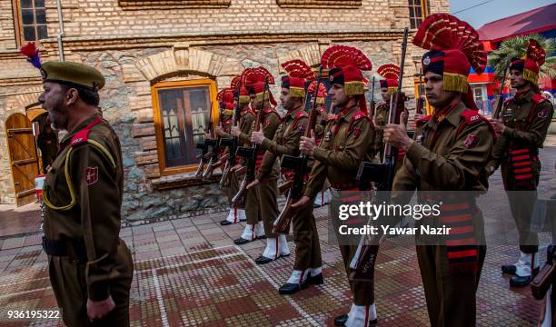 Honor guards of Indian police stand in formation as they honor the coffin containing the body of their comrade, Deepak Thusoo, killed in a gun battle...
