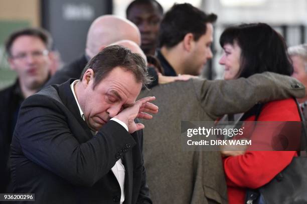 People grieve as they gather for the anniversary of the 2016 terrorist attacks in Brussels, at Brussel's main Airport on March 22, 2018. On March 22...