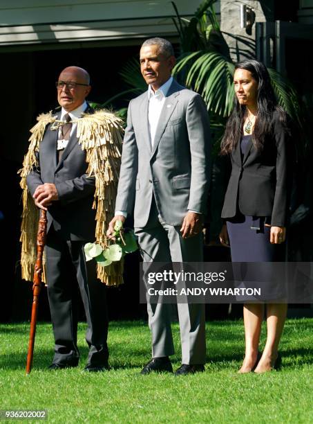 Former US president Barack Obama stands with Professor Piri Sciascia and community member Te Amohaere Morehu as he receives a traditional Maori...