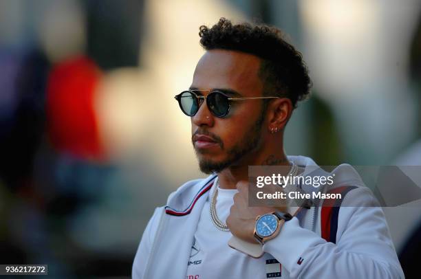 Lewis Hamilton of Great Britain and Mercedes GP looks on in the Paddock during previews ahead of the Australian Formula One Grand Prix at Albert Park...