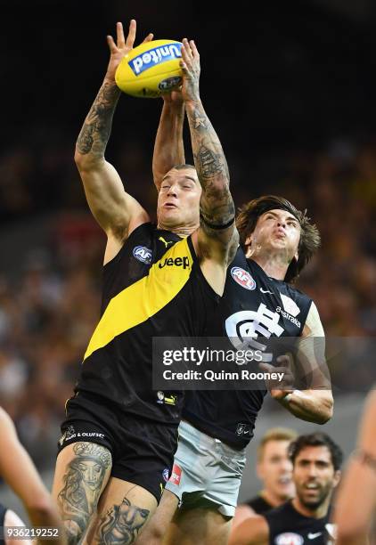 Dustin Martin of the Tigers marks infront of Caleb Marchbank of the Blues during the round one AFL match between the Richmond Tigers and the Carlton...