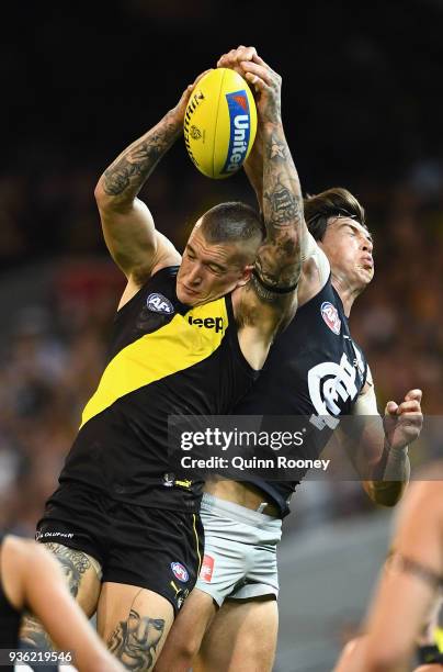 Dustin Martin of the Tigers marks infront of Caleb Marchbank of the Blues during the round one AFL match between the Richmond Tigers and the Carlton...