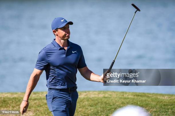 Rory McIlroy of Northern Ireland celebrates and raises his putter after making a long birdie putt on the 14th hole green during round one of the...