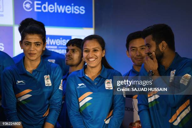 Indian hockey team captains Manpreet Singh and Rani Rampal share a light moment during the send-off ceremony for the Indian contingent of the XXI...