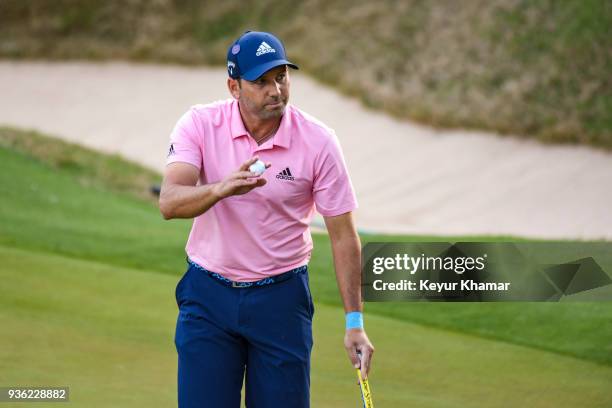 Sergio Garcia of Spain waves his ball to fans after making a putt on the 17th hole green during round one of the World Golf Championships-Dell...