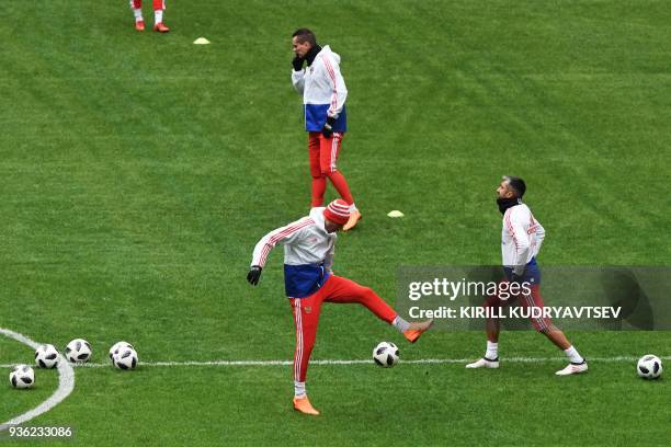 Russia's forwards Anton Zabolotny and Fyodor Smolov and midfielder Alexander Samedov take part in a training session at the Luzhniki stadium in...